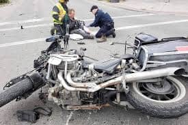 An injured biker is being helped by other bikers after he suffered a crash.