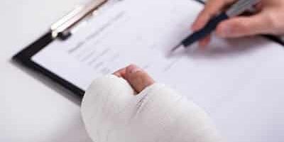 Person With Fractured Hand Filling Auto Accident Loans After Incident
