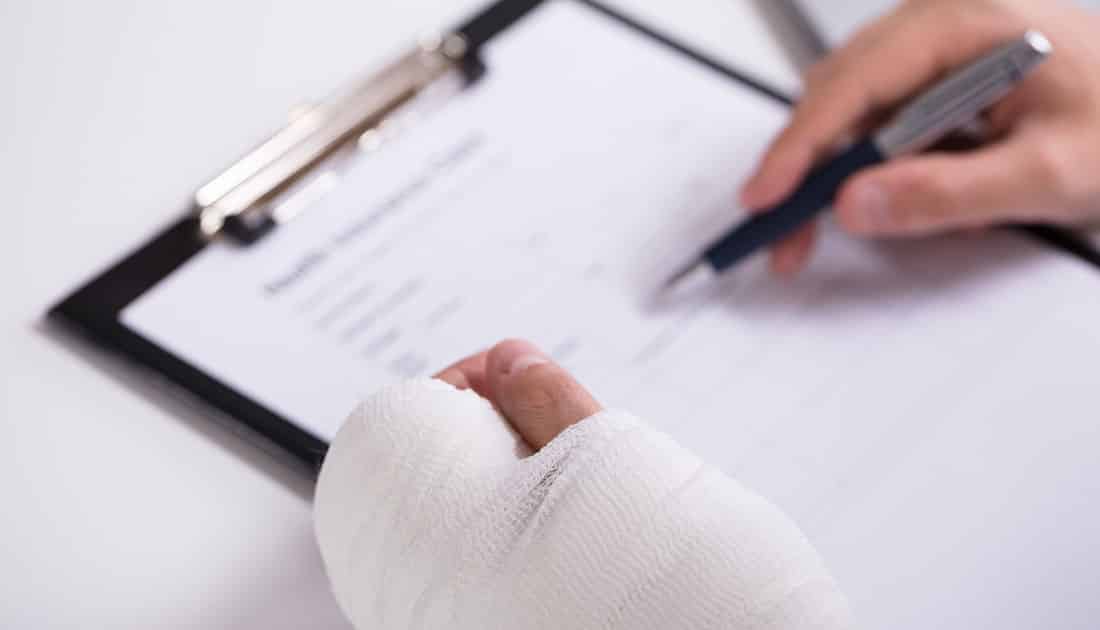 Person with auto accident injuries signs a personal injury claims and goes through the financial aspect of a PI claim with his attorney personal injury claim in arizona