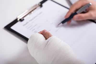 Person With Fractured Hand Filling Auto Accident Loans after Incident