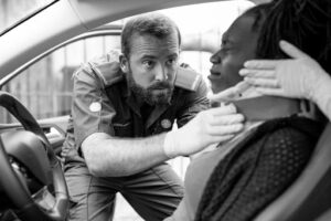 A paramedic assisting a woman that have a neck car accident injury.