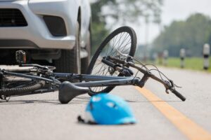 a bicycle lying on the floor crushed after an accident