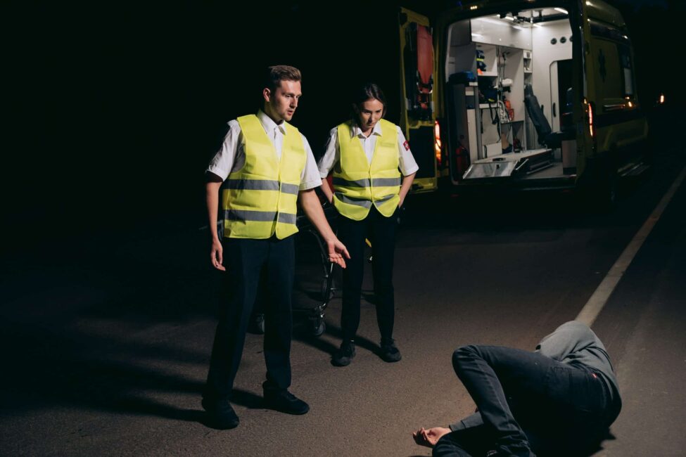 paramedics looking at the person experiencing pain and suffering after an accident