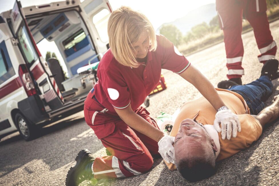 Staff rescuing a man involved In a hit and run at a stop sign