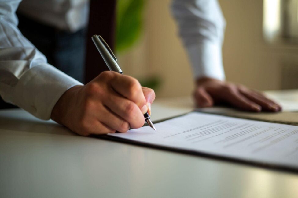 man signing a deal with at fault driver's insurance company