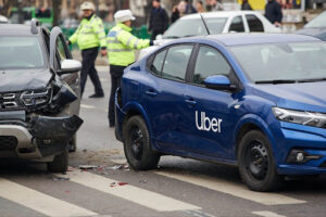 A car accident between a grey and a blue car. It's a Uber accident.