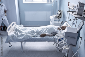 young injured man lying in bed hospital room resting from pain highlighting the severity of head-on collisions.