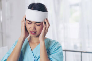 a woman hospitalized for a mild brain injury after a car accident waiting for brain injury lawyers