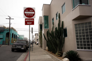 a sign showing wrong way driving.