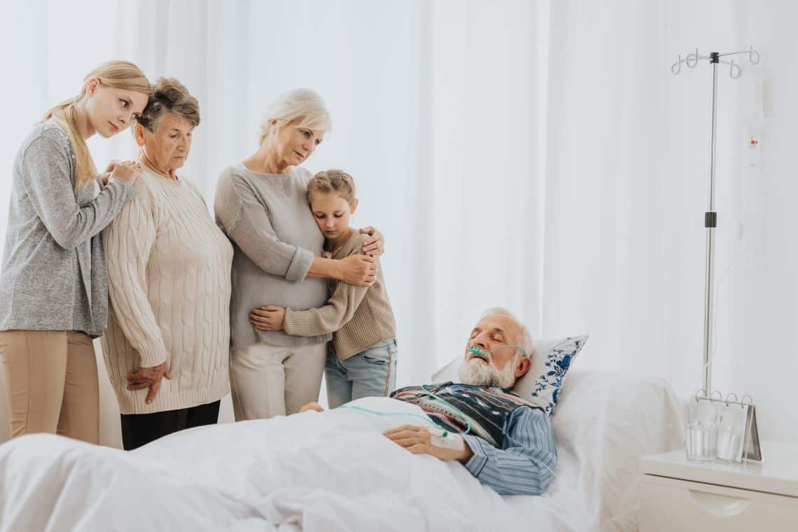 family gathers around the bed of a man who suffered a wrongful death in a nursing home, so they will file for a wrongful death settlements in Arizona